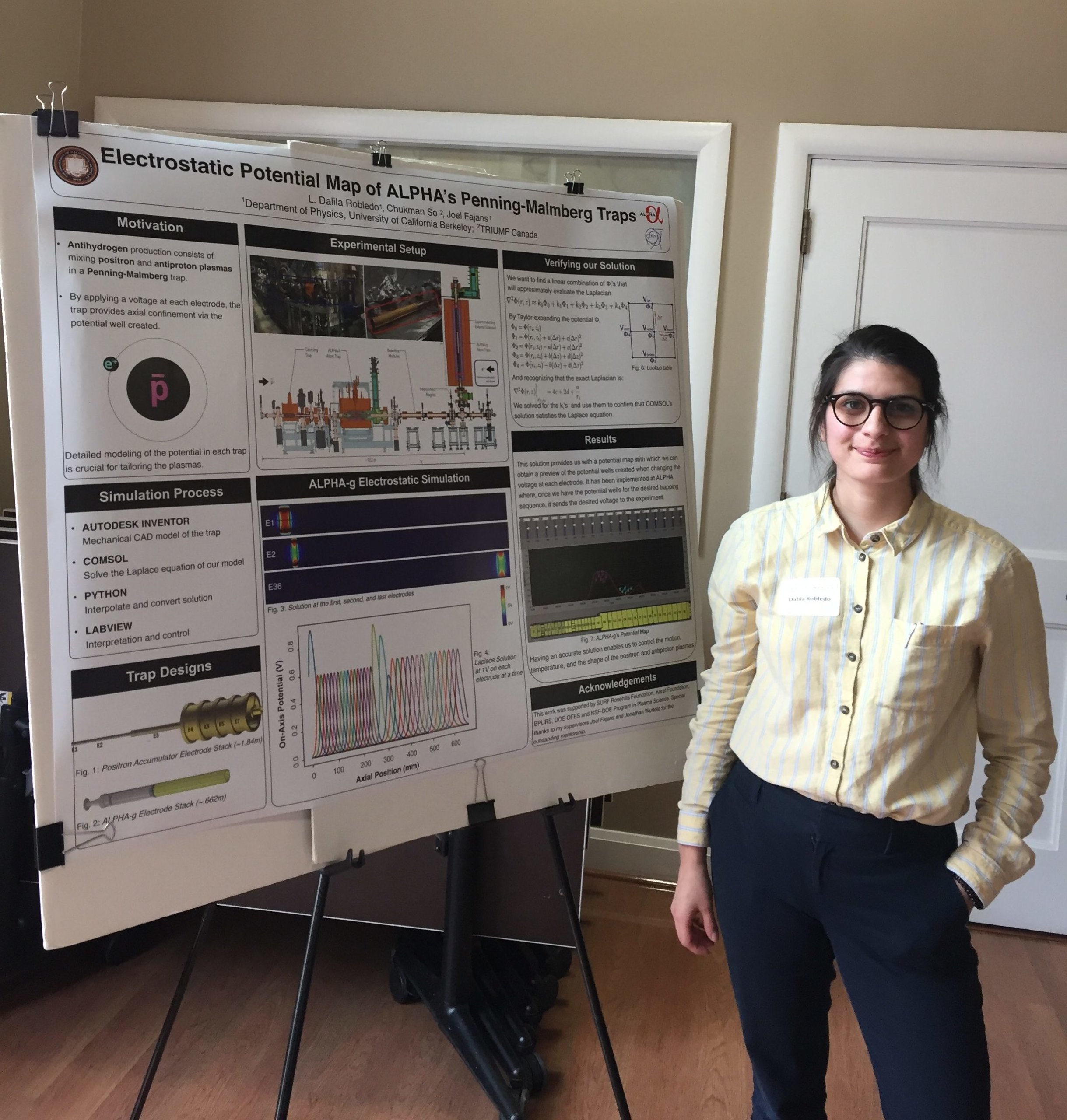 Dalila Robledo stands in front of a board displaying her research during a science presentation for school.
