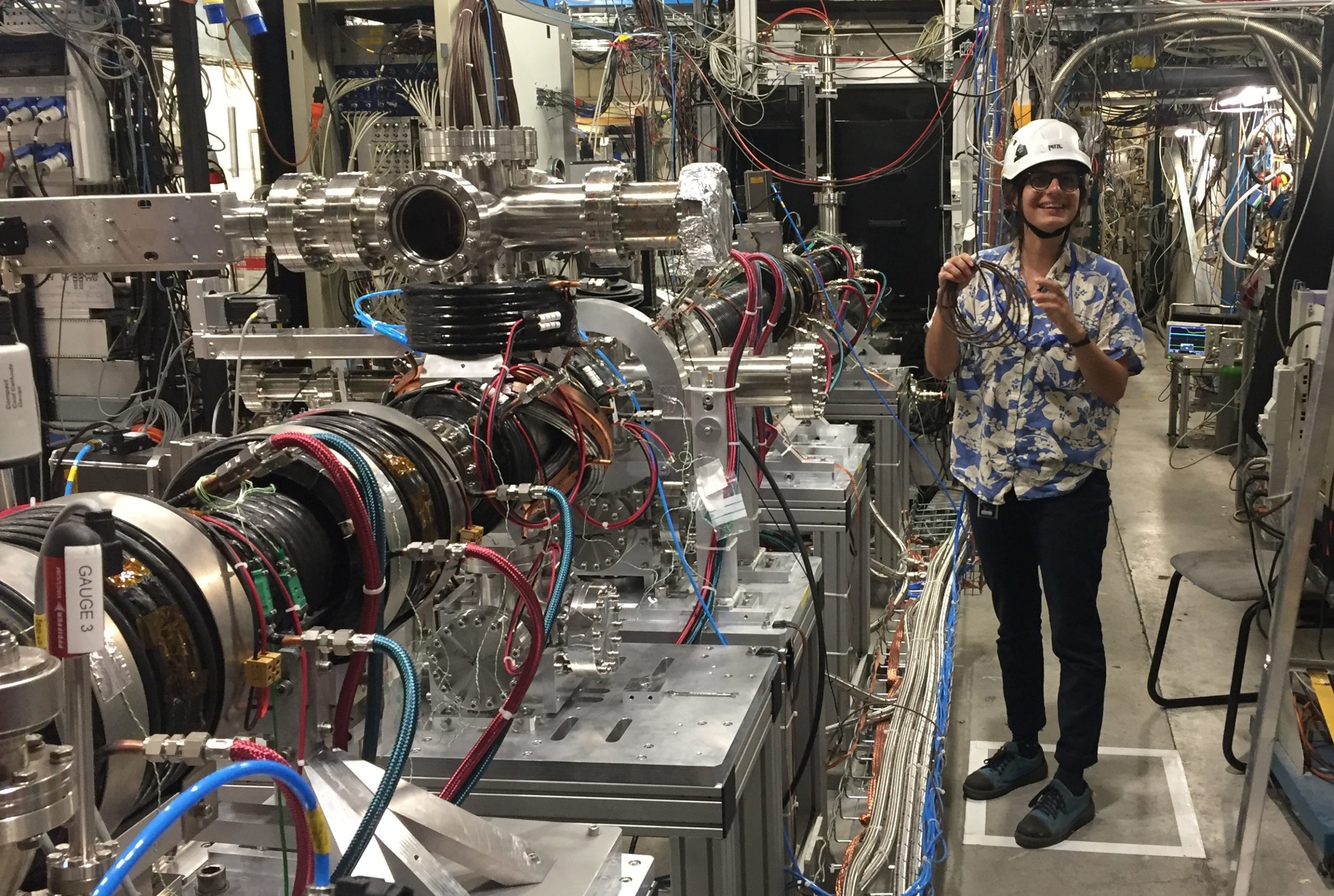 Robledo, a scholarship winner for service-minded students, smiles while standing in the CERN facility.