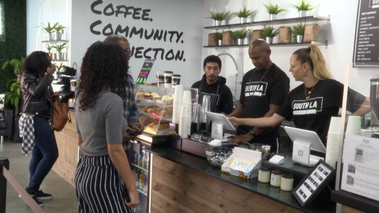 Customers place an order at a coffee shop that received an SBA 7(a) Community Advantage loan from CDC Small Business Finance.