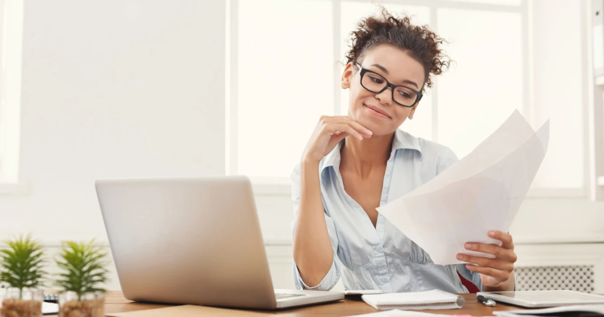 A small business owner reviews their 12-month financial projection, created from CDC Small Business Finance's free template.