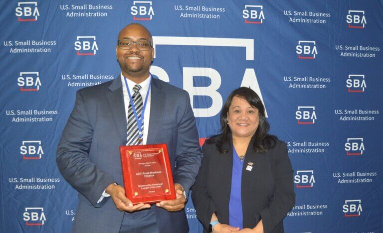 Nimaj Driscoll (left) is a Detroit-based loan officer ​​who provides financing to borrowers throughout Michigan for CDC Small Business Finance. He is pictured here — receiving the “Community Advantage Lender of the Year” award on behalf of CDC Small Business Finance — with SBA Regional Administrator Geri Sanchez Aglipay.