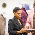 Montee goes over designs with a member of his team