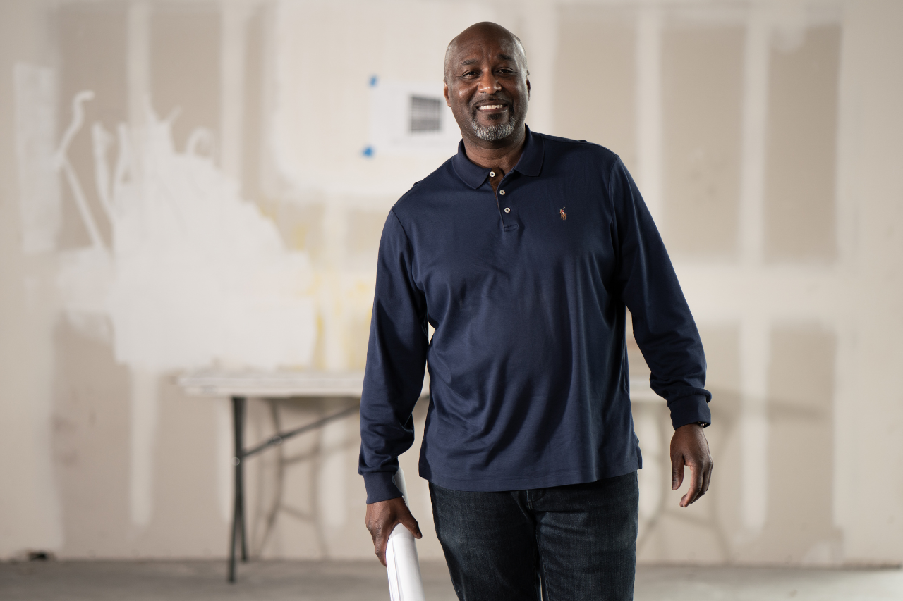 SBA Community Advantage Program helps small businesses who can't get funding elsewhere - picture of black entrepreneur with blueprints on a building site