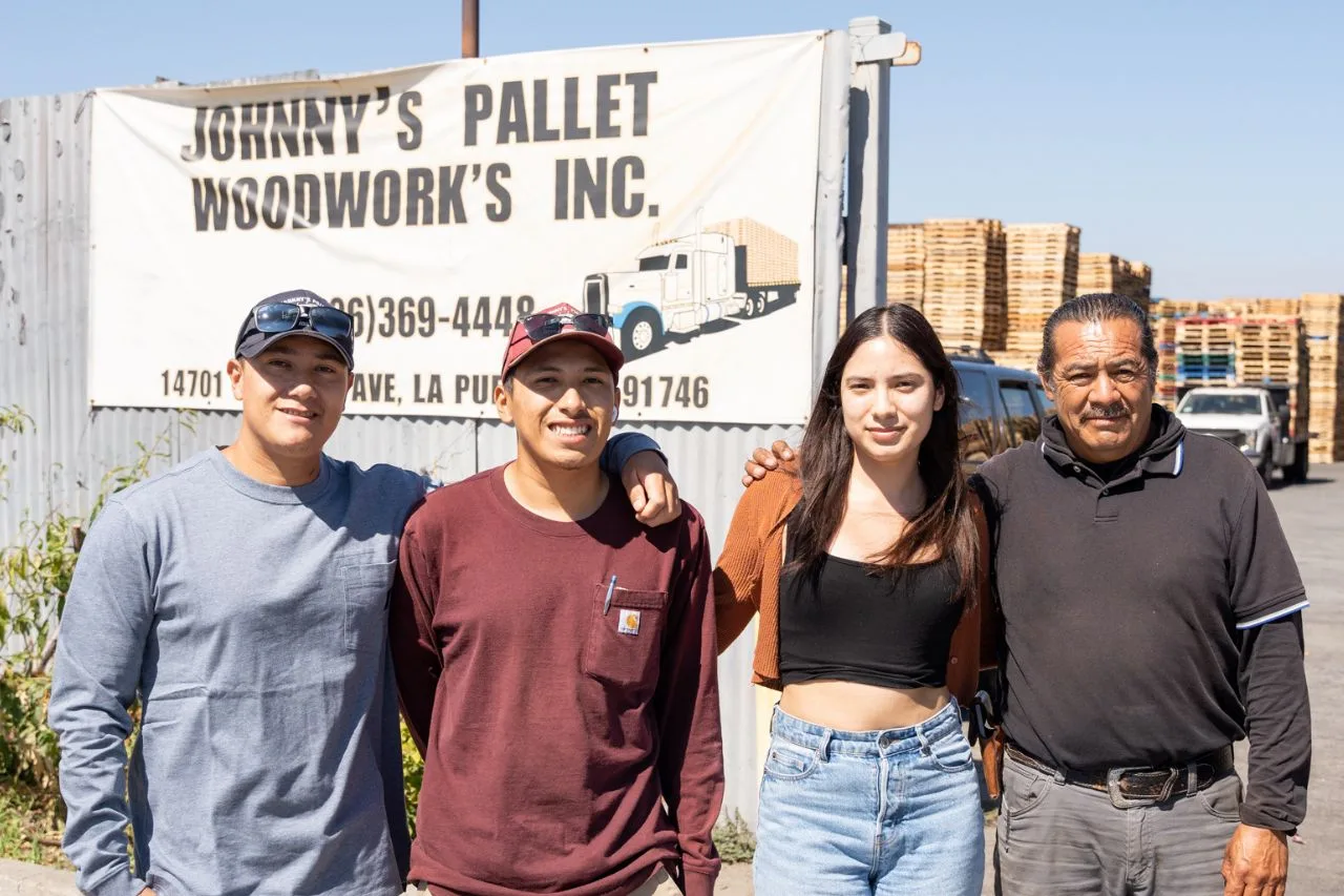 Juan and family in front of their Pallet Woodwork's lot, which was financed by an SBA 504 Loan from CDC Small Business Finance.