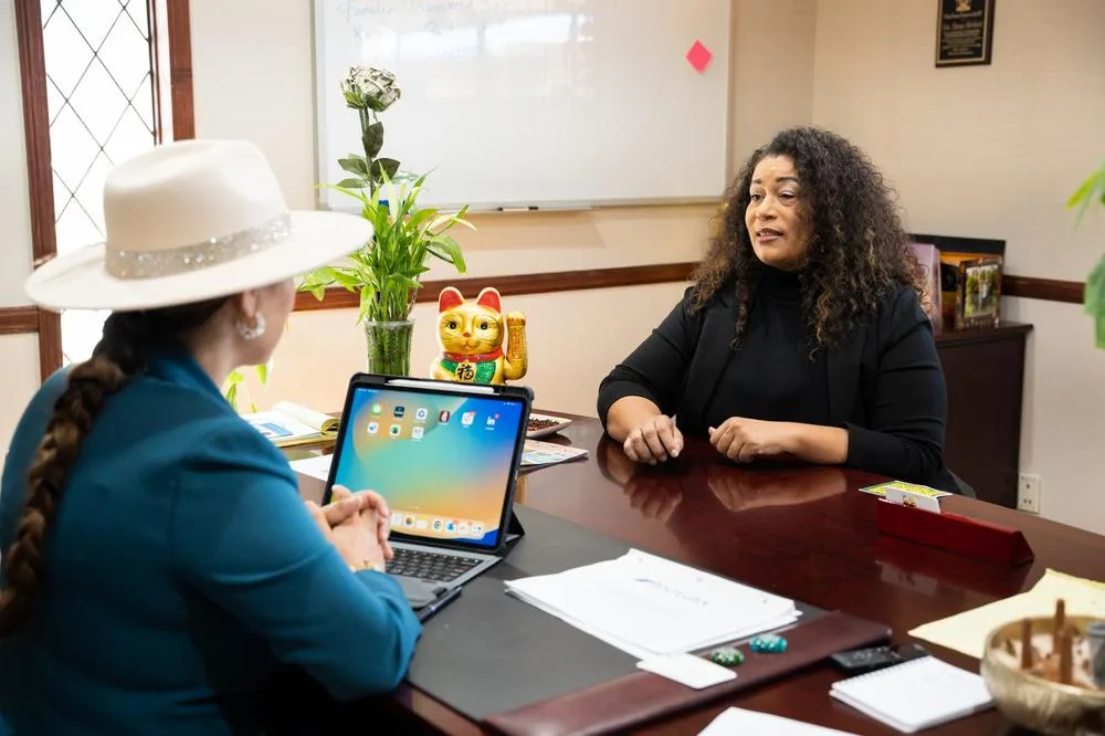 Herbert Financial Group's founder Tania Herbert speaks to CDC Small Business Finance loan officer Janine Peltier in her new HFG office.