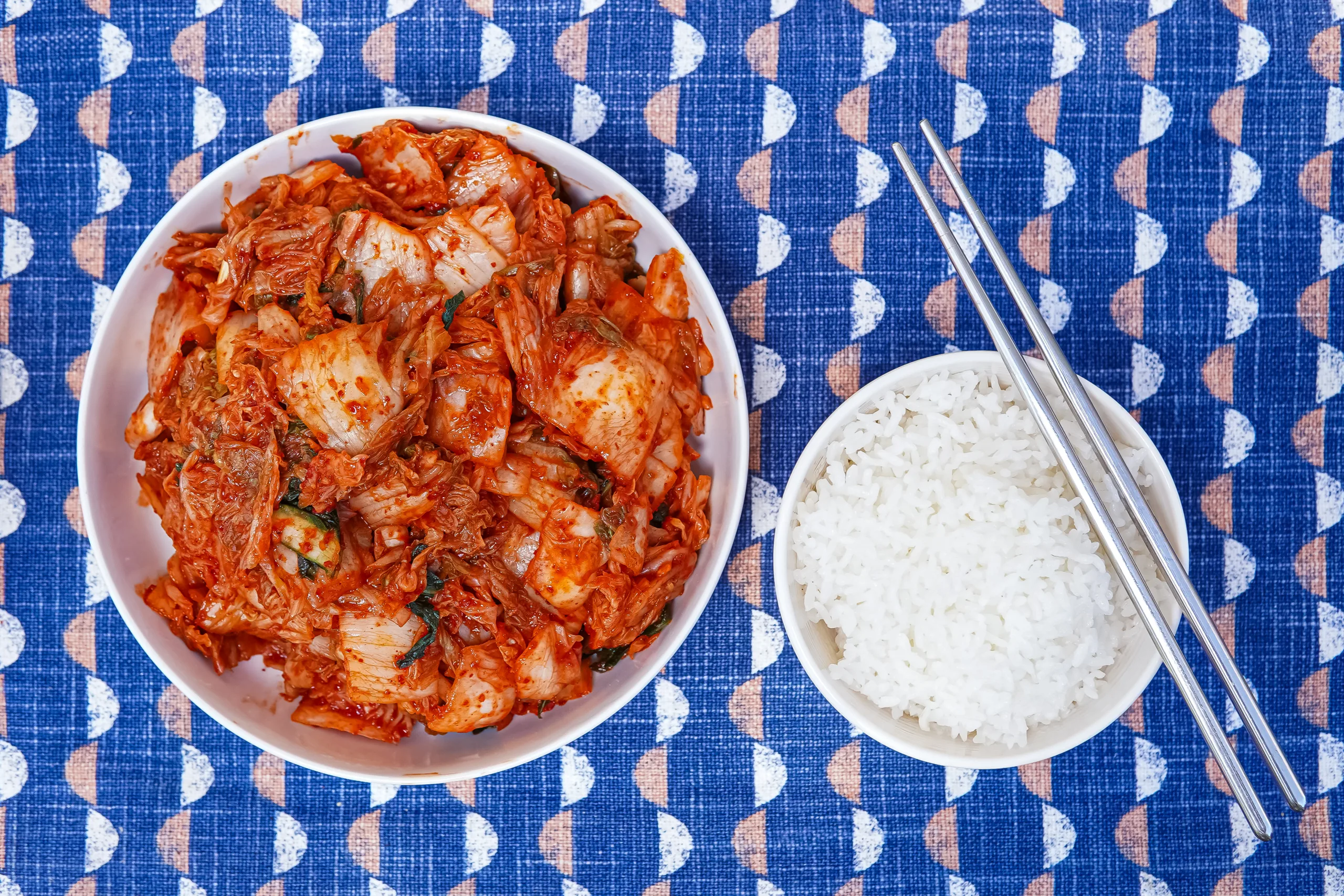 Tae-Gu Kimchi, beautifully presented from above with a bowl of rice and chopsticks to one side.