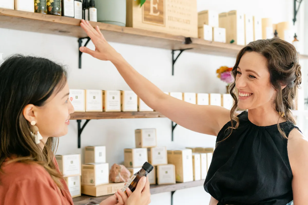 Jessica's Apothecary -Jessica shows a customer some of her products.