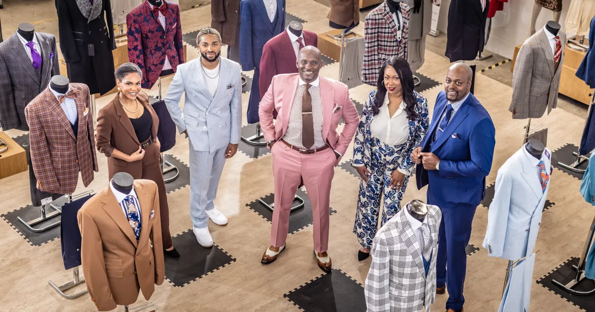 The Tayion Collection staff stands together featuring many of their designs. Impact Investment’s non-dilutive funding helps businesses with growth capital through alternative funding options.