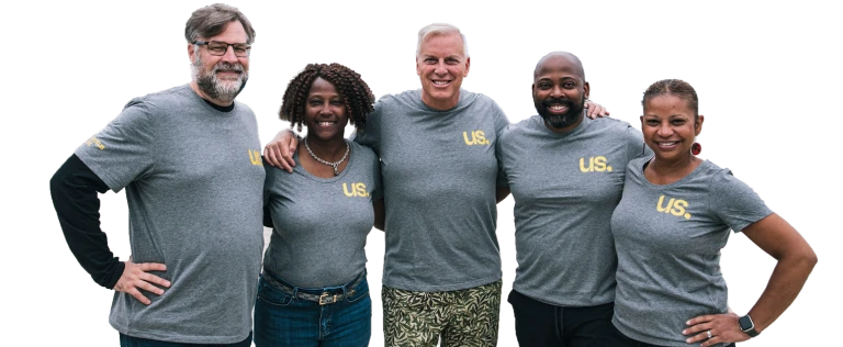 The Momentus Capital Executive Management team gathers together at a company event, all wearing the same t-shirt and smiling (transparent background).