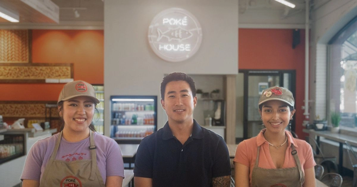 Poke House owner and two of his employees sit in their new franchise.