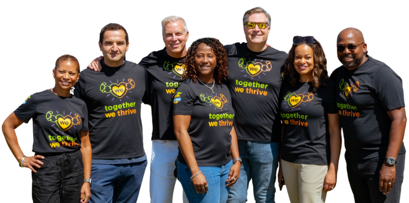 The Momentus Capital Executive Management team gathers together at the 2025 company all staff event, all wearing the same t-shirt and smiling.
