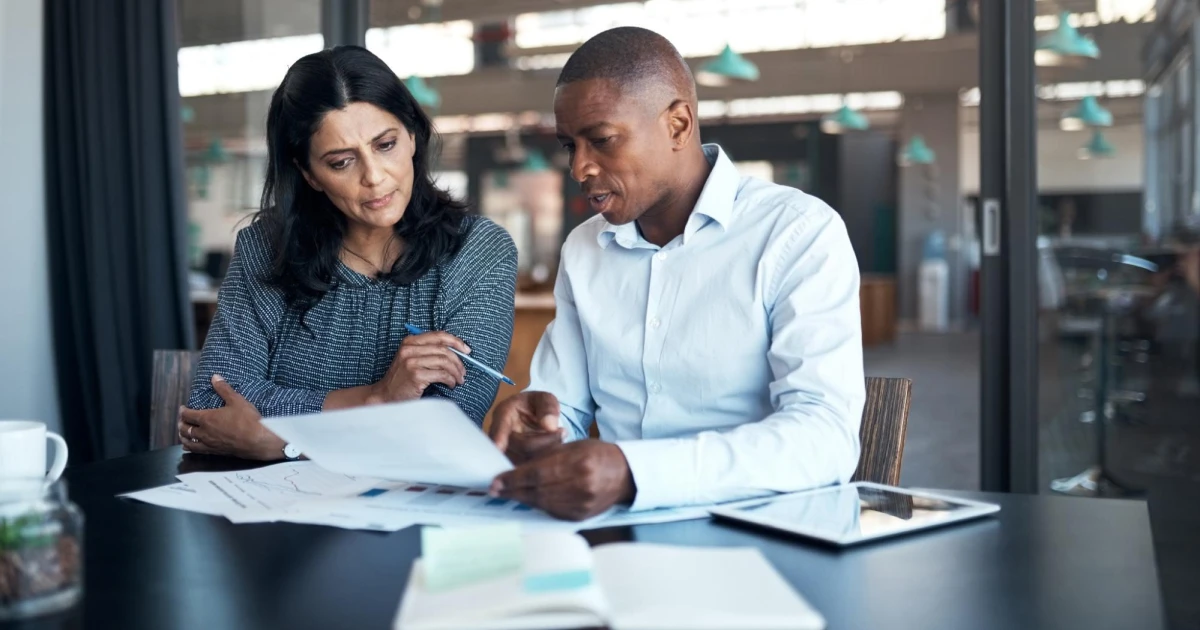 Small business owner reviewing commercial real estate documents with an advisor