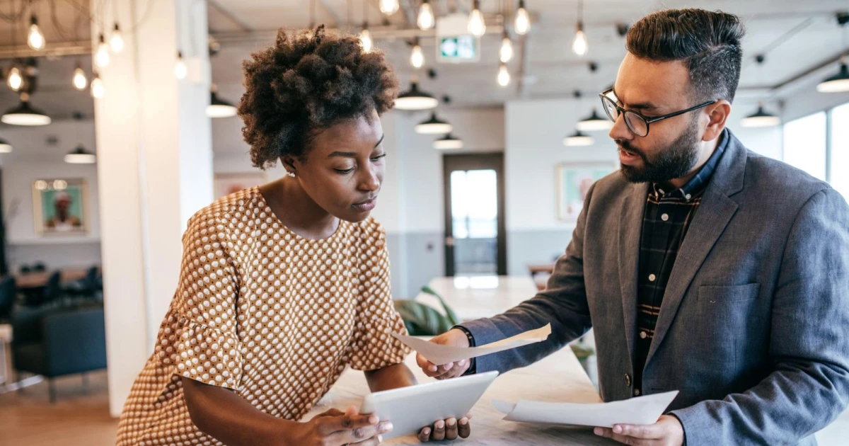 Business owner reviewing commercial real estate financing documents with a loan officer.